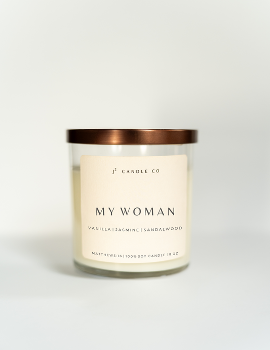 My Woman soy candle, 8 oz with bronze lid, labeled Vanilla, Jasmine, Sandalwood, in a clear glass jar.